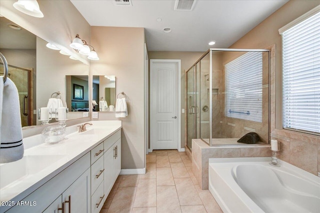 bathroom with vanity, tile patterned flooring, and plus walk in shower