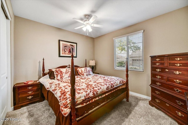 bedroom featuring ceiling fan, light colored carpet, and a closet