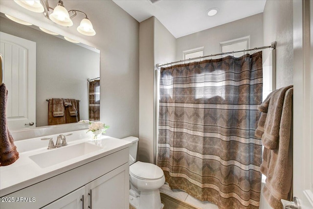 bathroom with toilet, vanity, and a shower with curtain