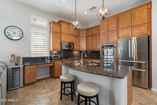 9262 E Desert Park Dr, Scottsdale, AZ 85255 - kitchen with appliances with stainless steel finishes, decorative backsplash, dark stone countertops, beverage cooler, and recessed lighting