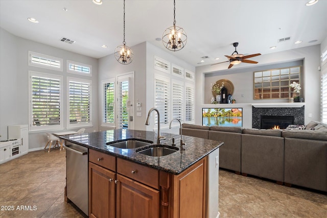 9262 E Desert Park Dr, Scottsdale, AZ 85255 - kitchen featuring dishwasher, brown cabinets, dark stone countertops, recessed lighting, and a center island with sink