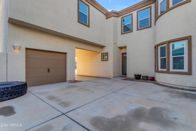 back of house with a garage