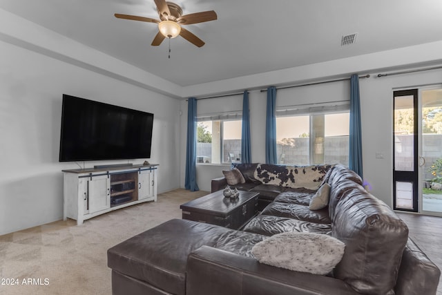 carpeted living room featuring ceiling fan and plenty of natural light