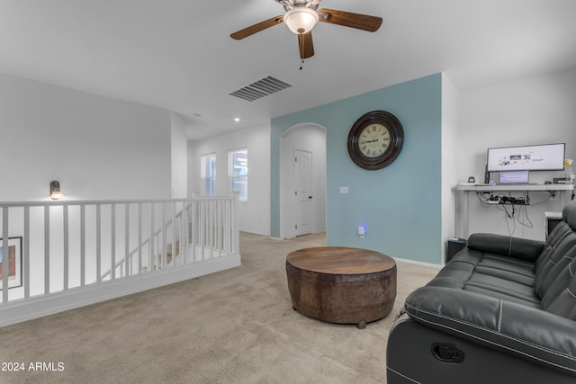 carpeted living room featuring ceiling fan