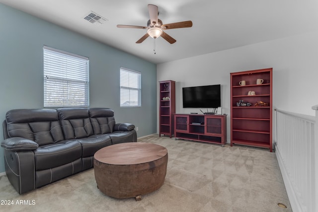 carpeted living room with ceiling fan