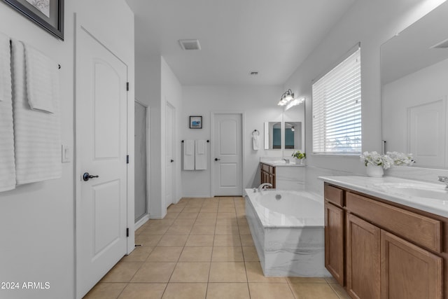 bathroom featuring tile patterned floors, a bathing tub, and vanity