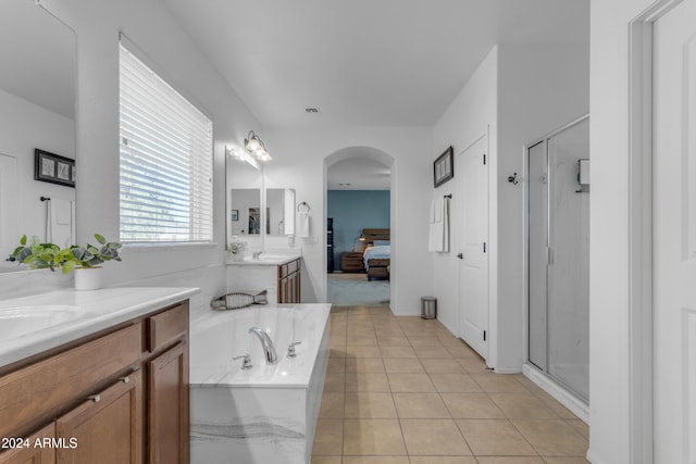 bathroom featuring tile patterned flooring, vanity, and independent shower and bath