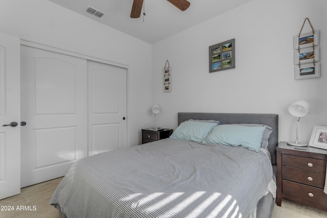 bedroom with light carpet, a closet, and ceiling fan