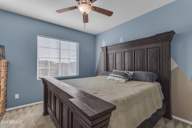 bedroom featuring light carpet and ceiling fan