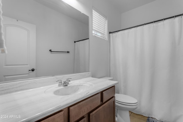 bathroom with tile patterned floors, vanity, and toilet