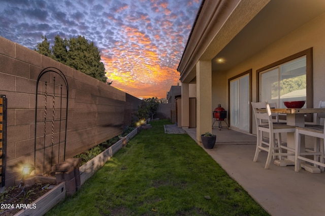 yard at dusk with a patio area