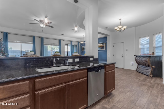 kitchen with stainless steel dishwasher, wood-type flooring, sink, and a wealth of natural light