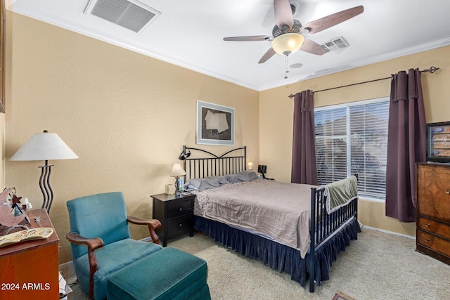 bedroom featuring light carpet, ceiling fan, and crown molding