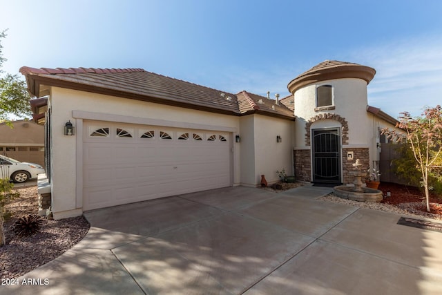 mediterranean / spanish-style home featuring a garage