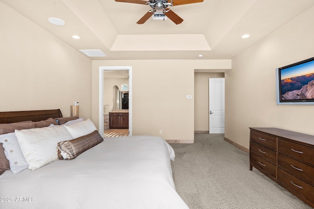 bedroom with a raised ceiling, recessed lighting, baseboards, and light carpet