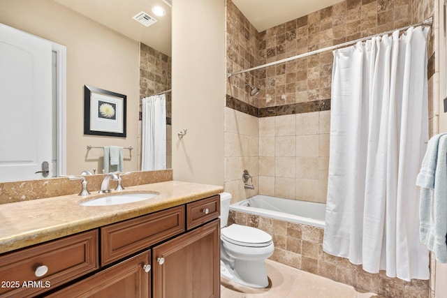 full bathroom featuring vanity, visible vents, tiled shower / bath combo, tile patterned floors, and toilet