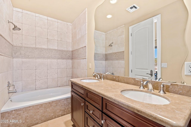 bathroom featuring tile patterned flooring, double vanity, visible vents, and a sink