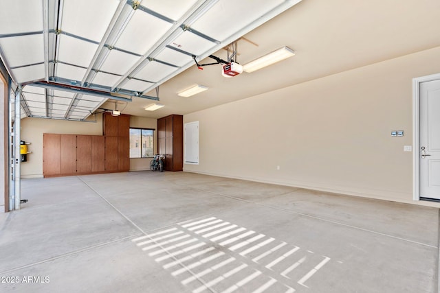 garage with a garage door opener and baseboards