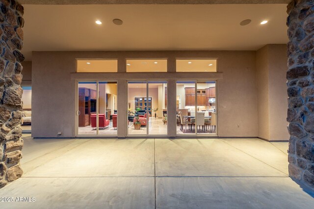 view of exterior entry with stucco siding