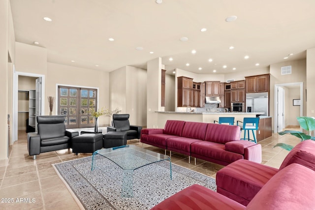 living area with light tile patterned floors, visible vents, recessed lighting, and french doors