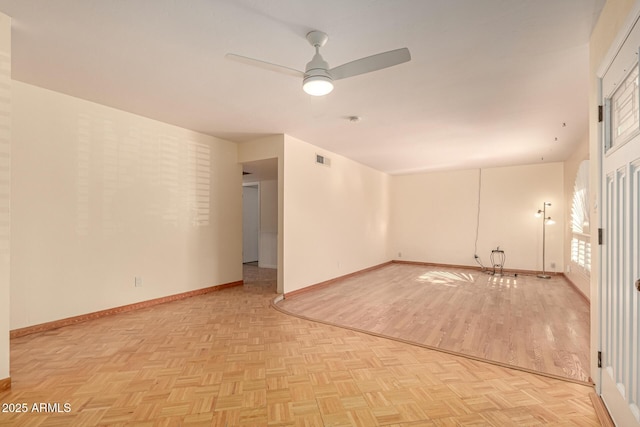 empty room featuring light parquet floors and ceiling fan