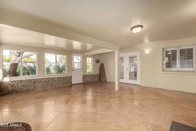 unfurnished room featuring french doors