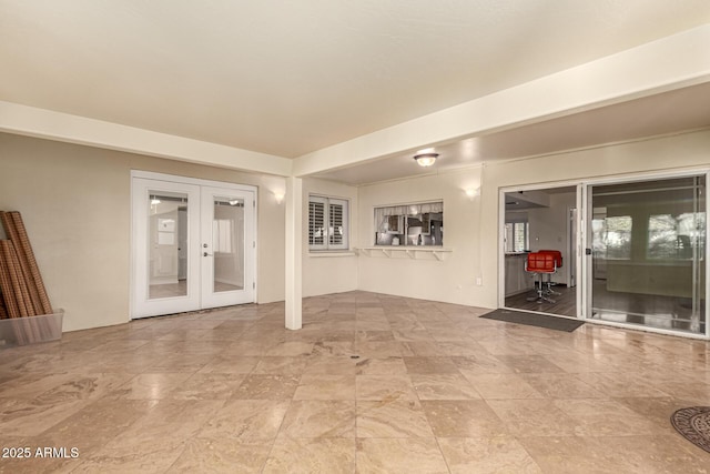 unfurnished room featuring french doors