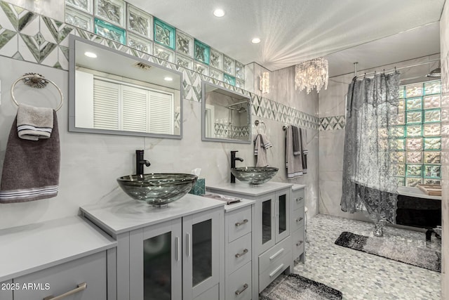 bathroom featuring vanity, a notable chandelier, and walk in shower