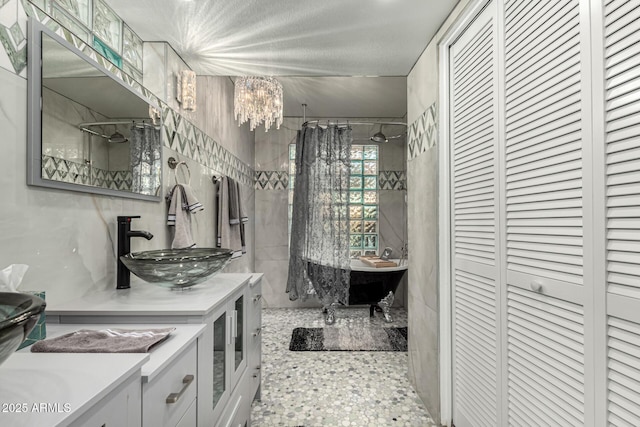 bathroom with separate shower and tub, vanity, a textured ceiling, and a notable chandelier