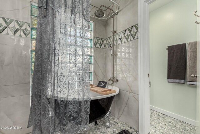 bathroom with independent shower and bath and tile walls