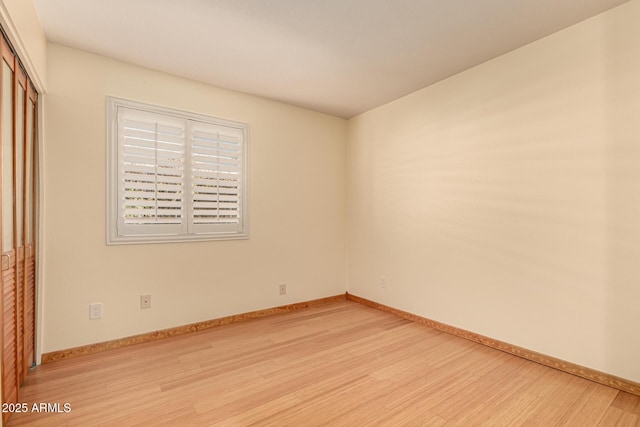 empty room with light hardwood / wood-style flooring