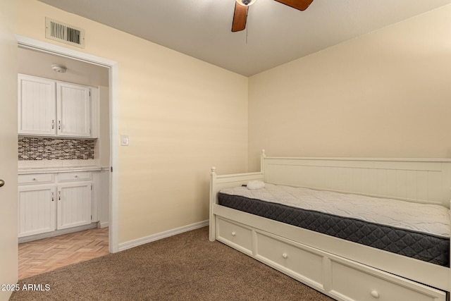 bedroom with ceiling fan and parquet flooring