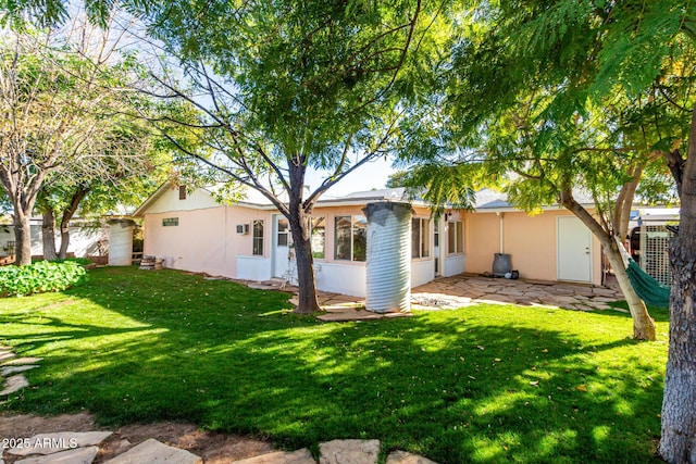 rear view of house with a yard