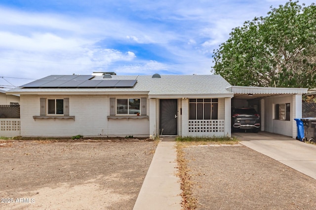 2801 W Glenrosa Ave, Phoenix, AZ 85017 - ranch-style home featuring an attached carport, solar panels, a shingled roof, driveway, and brick siding
