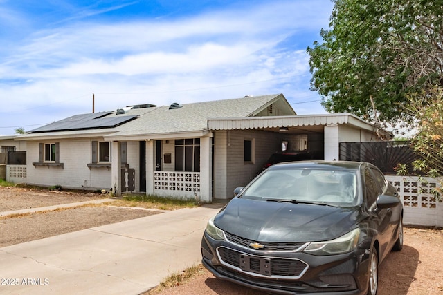 2801 W Glenrosa Ave, Phoenix, AZ 85017 - single story home featuring brick siding, roof mounted solar panels, a shingled roof, and a carport