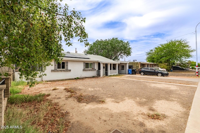 2801 W Glenrosa Ave, Phoenix, AZ 85017 - single story home featuring roof mounted solar panels, brick siding, and driveway