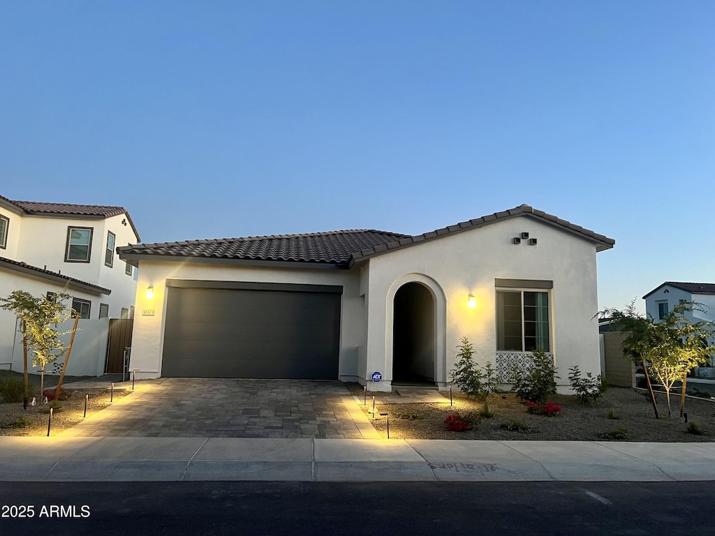 mediterranean / spanish home with a garage