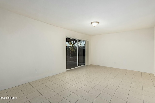 unfurnished room featuring light tile patterned flooring