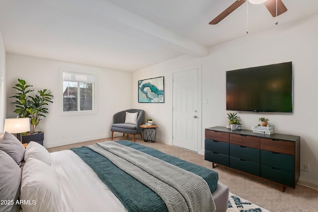 bedroom with beamed ceiling, light carpet, and ceiling fan