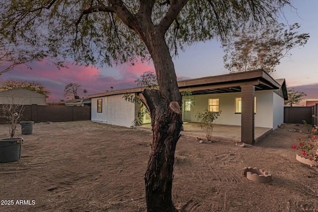 view of back house at dusk