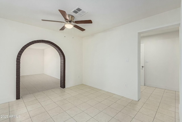 tiled empty room with ceiling fan