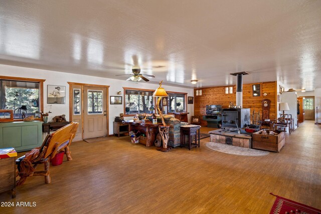 1528 Black Canyon Rd, Heber, AZ 85928 - living area featuring a wood stove, wood finished floors, and ceiling fan