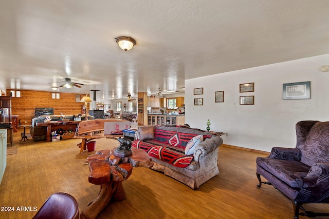 1528 Black Canyon Rd, Heber, AZ 85928 - living room with wood finished floors, a ceiling fan, baseboards, and a textured ceiling