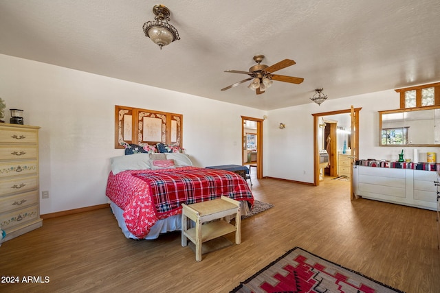 1528 Black Canyon Rd, Heber, AZ 85928 - bedroom with light wood-style flooring, baseboards, connected bathroom, and a textured ceiling