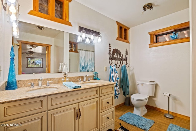 1528 Black Canyon Rd, Heber, AZ 85928 - bathroom featuring double vanity, toilet, wood finished floors, baseboards, and curtained shower