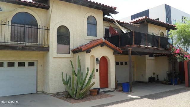319 E Coronado Rd Unit 1, Phoenix, AZ 85004 - mediterranean / spanish home with a balcony, an attached garage, and stucco siding