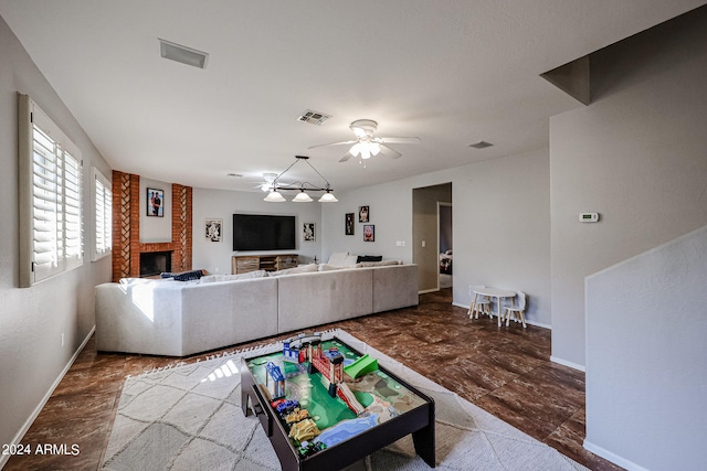 living room with a brick fireplace and ceiling fan