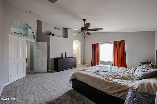 carpeted bedroom featuring lofted ceiling and ceiling fan