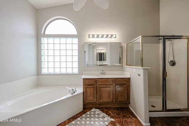 bathroom with independent shower and bath, vanity, vaulted ceiling, and ceiling fan