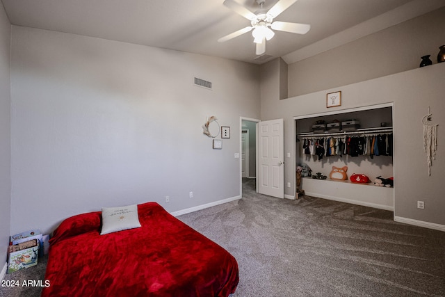 bedroom with ceiling fan, carpet floors, a closet, and a high ceiling